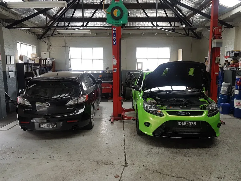 Vehicles on hoists being inspected in the City Service Mechanics workshop