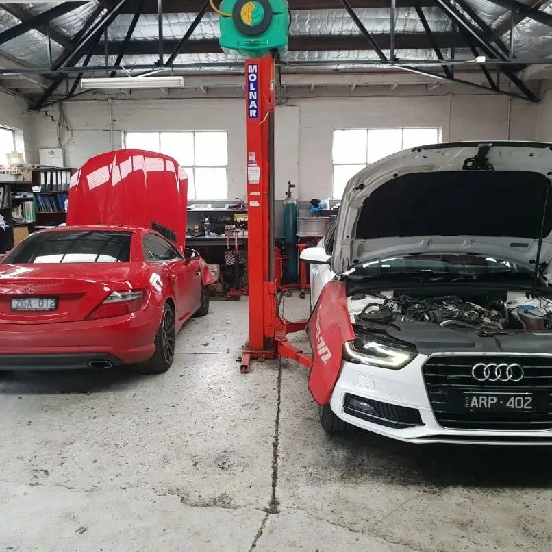 Vehicles on hoists undergoing safety inspections in the North Melbourne workshop