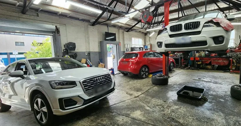 Several vehicles being inspected and repaired in the workshop
